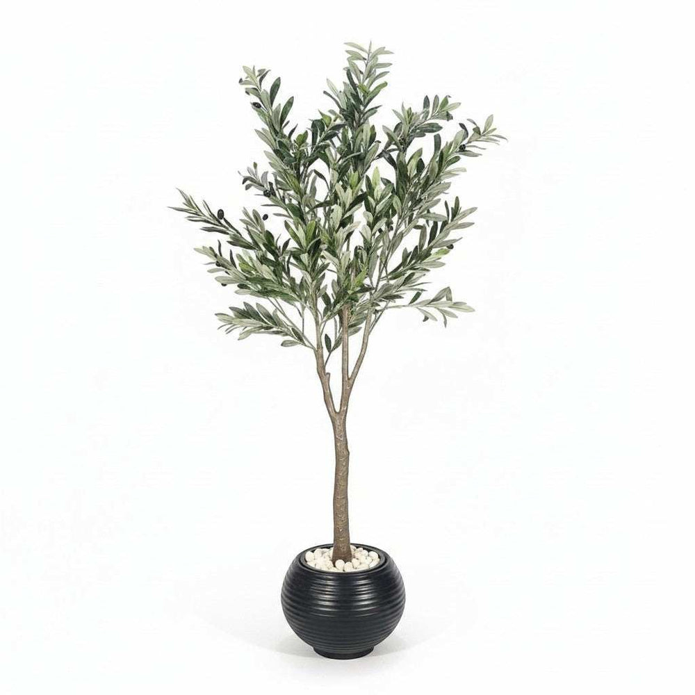 Wadi Home artificial olive tree with realistic green leaves and olives in a black ribbed planter with white stones.