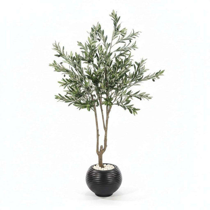 Wadi Home artificial olive tree with green leaves and black olives in a black ribbed pot with white stones.
