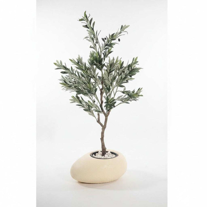 Wadi Home artificial olive tree with green leaves and olives in a stone-effect pot with white pebbles.