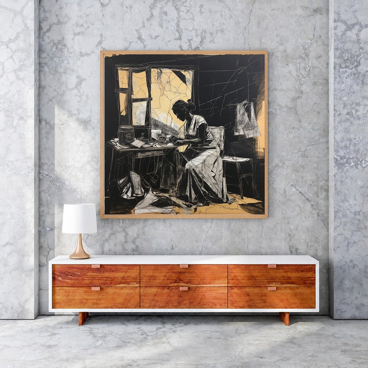 Wadi Home black and white sketch wall art of a woman working at a table with golden accents.