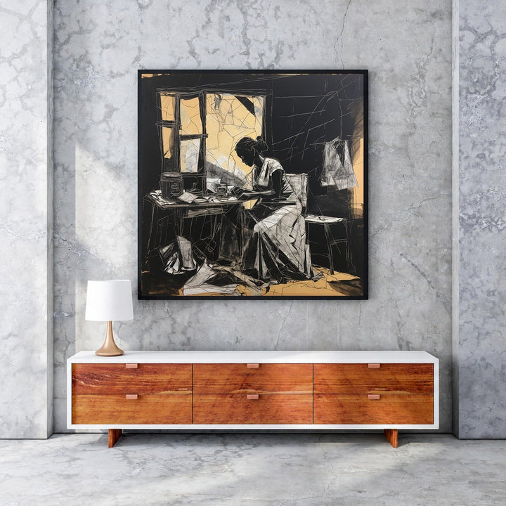 Wadi Home black and white sketch wall art of a woman working at a table, with subtle golden accents. Framed art.