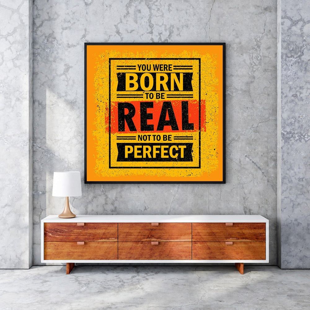 Wadi Home motivational wall art with bold yellow, black, and red typography reading 'You Were Born To Be Real Not To Be Perfect'.