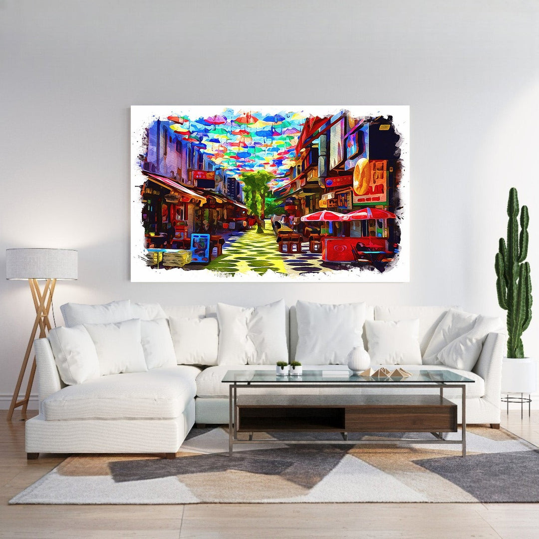 Wadi Home canvas print of a colorful street scene with many bright umbrellas overhead and shops lining the street.