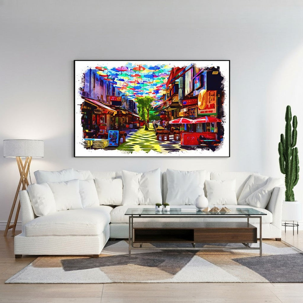 Wadi Home canvas print of a vibrant street scene with colorful umbrellas overhead and watercolor-inspired buildings.