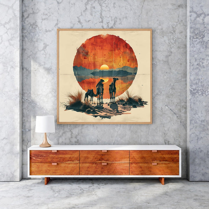 Wadi Home Desert Sunset Camel Caravan wall art featuring silhouetted camels against a circular, textured sunset over a desert landscape.