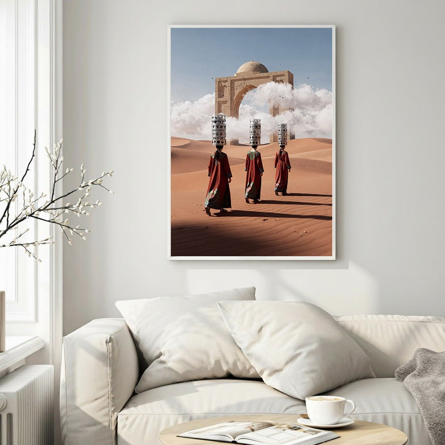 Wadi Home desert caravan art print featuring three figures in traditional robes carrying burdens across sand dunes towards an ancient archway.