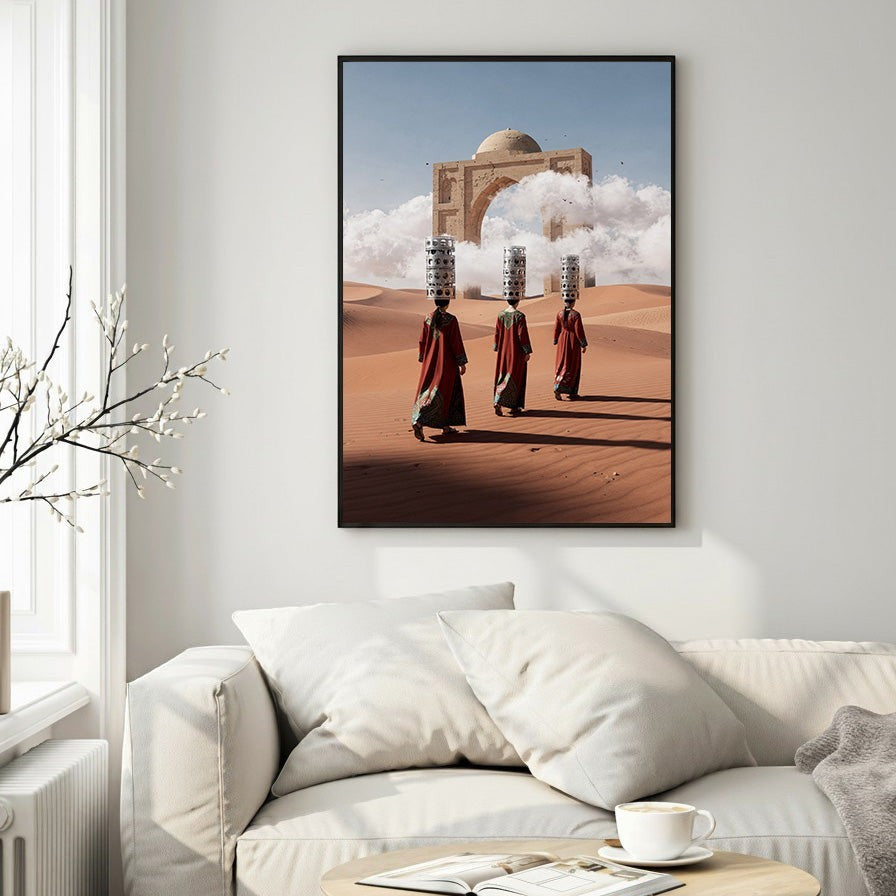 Wadi Home art print: Three figures in red robes carry burdens across a desert landscape towards an ancient archway with a domed structure.