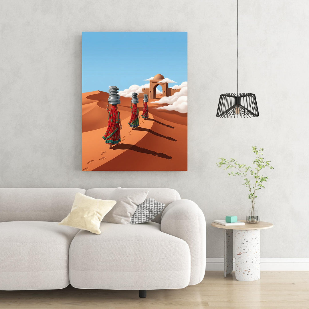 Wadi Home Desert Journey Wall Art: Three women in red and green saris walk across sand dunes carrying stacks of items on their heads. Archway in background.
