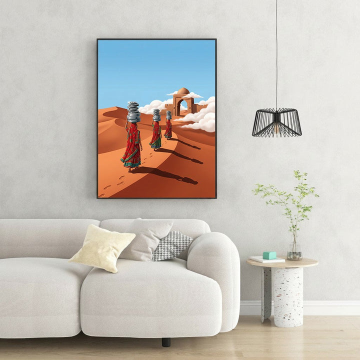 Wadi Home Desert Journey wall art depicts three women in red and green saris carrying stacked pots on their heads across sand dunes under a blue sky.
