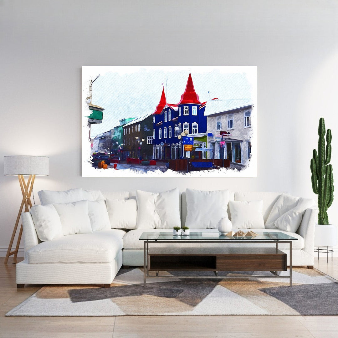 Wadi Home European streetscape watercolor art with blue buildings and red roofs, displayed above a white sectional sofa.