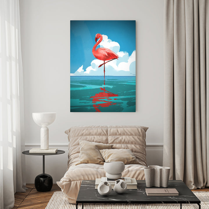 Wadi Home flamingo reflection on water wall art, vibrant pink flamingo standing on one leg in turquoise water under blue sky with clouds.