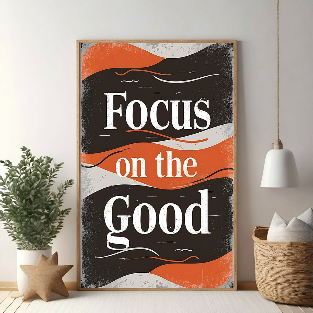 Wadi Home motivational wall art with bold white typography reading "Focus on the Good" against a distressed black and orange retro background.