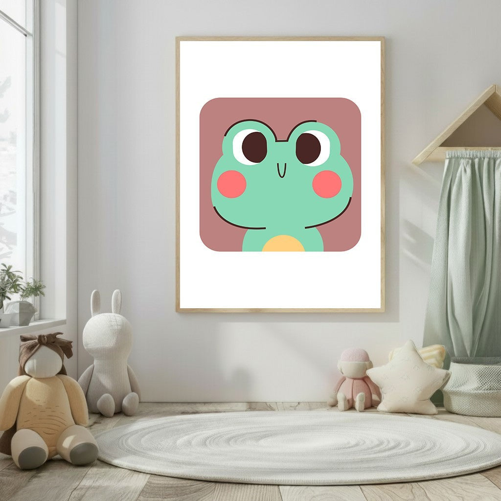 Wadi Home cute green frog face nursery art with pink cheeks and a yellow belly, framed in a light wood.