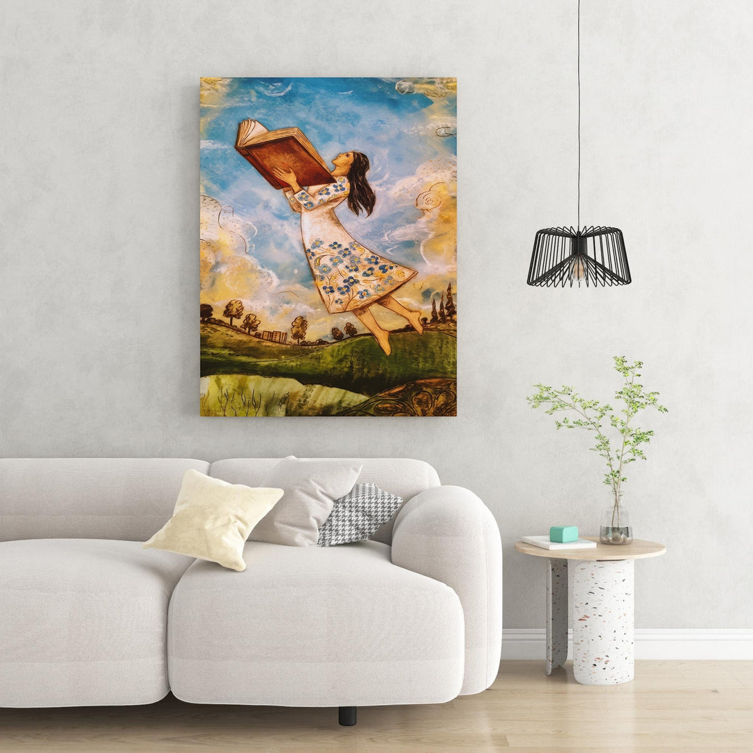 Wadi Home artwork: girl in white floral dress flying with open book, whimsical clouds and landscape.