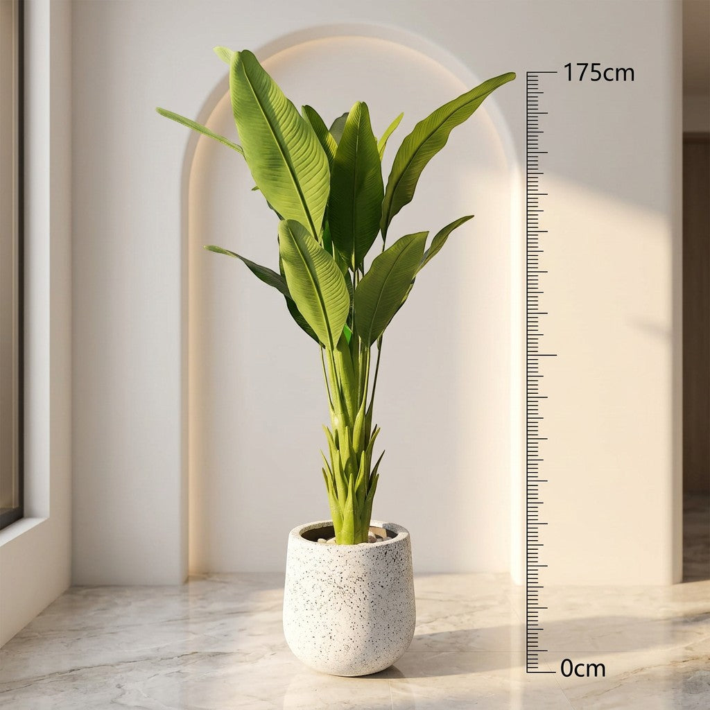 Wadi Home large faux Bird of Paradise plant with lush green leaves in a speckled white pot. Realistic tropical plant.