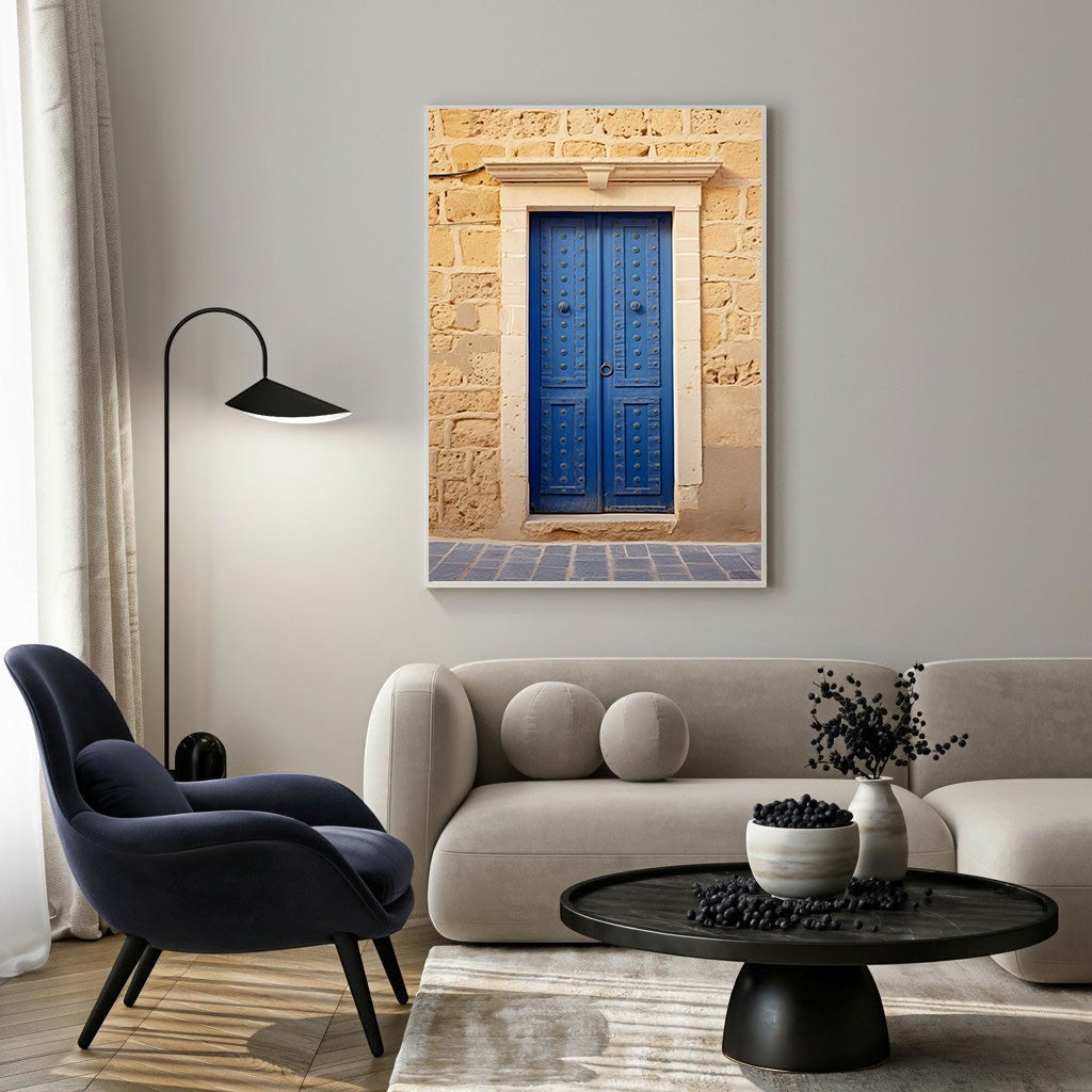 Wadi Home Mediterranean Blue Door wall art featuring a vibrant blue door with decorative hardware against a rustic stone wall.