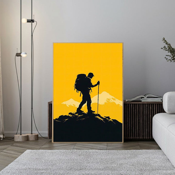 Wadi Home mountain climber silhouette art print with black hiker against yellow sky and snow-capped peaks.