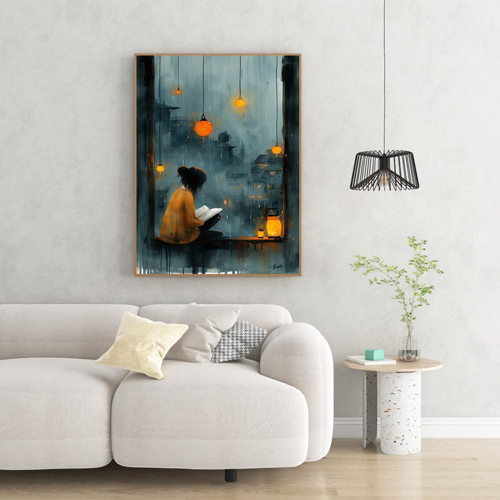 Wadi Home cozy reading nook wall art, woman reading by window on rainy night with glowing lanterns.