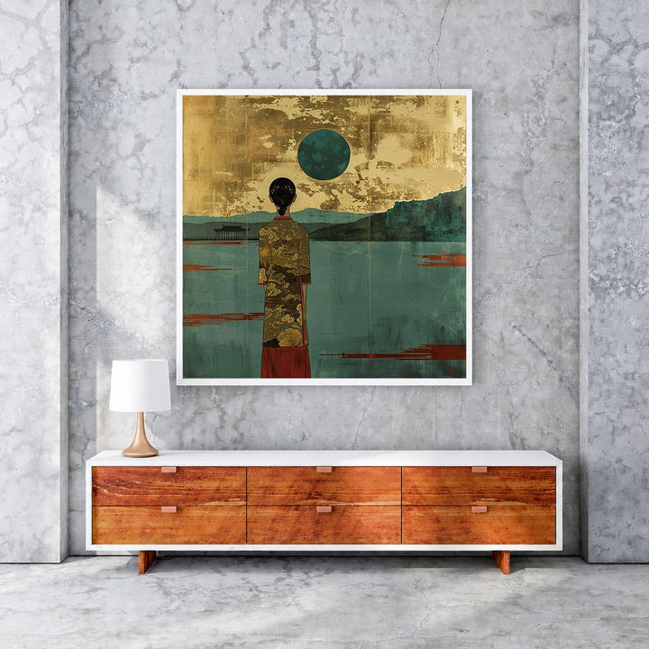 Wadi Home serene landscape wall art with a figure in a gold patterned robe gazing at a teal moon over water.