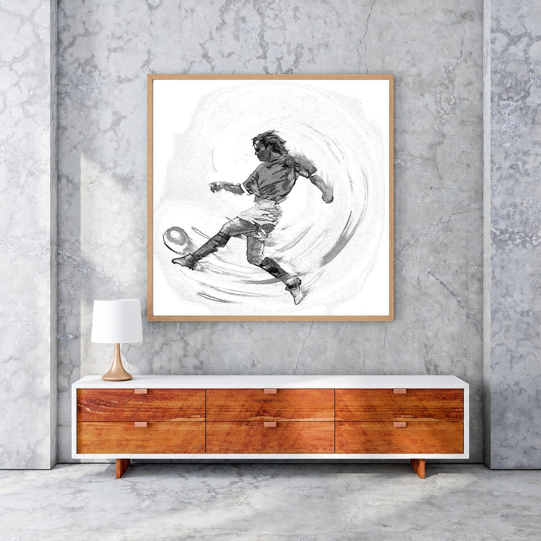 Wadi Home black and white sketch artwork of a soccer player in mid-kick, framed in wood. Dynamic action art.