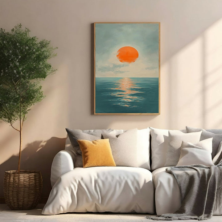 Wadi Home Serene Sunset Over Ocean Wall Art, featuring an oversized orange sun over deep blue water, framed in light wood.