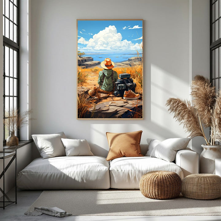 Wadi Home artwork: Traveler in straw hat and green jacket sits on rocks, gazing at ocean vista. Luggage and boots nearby.