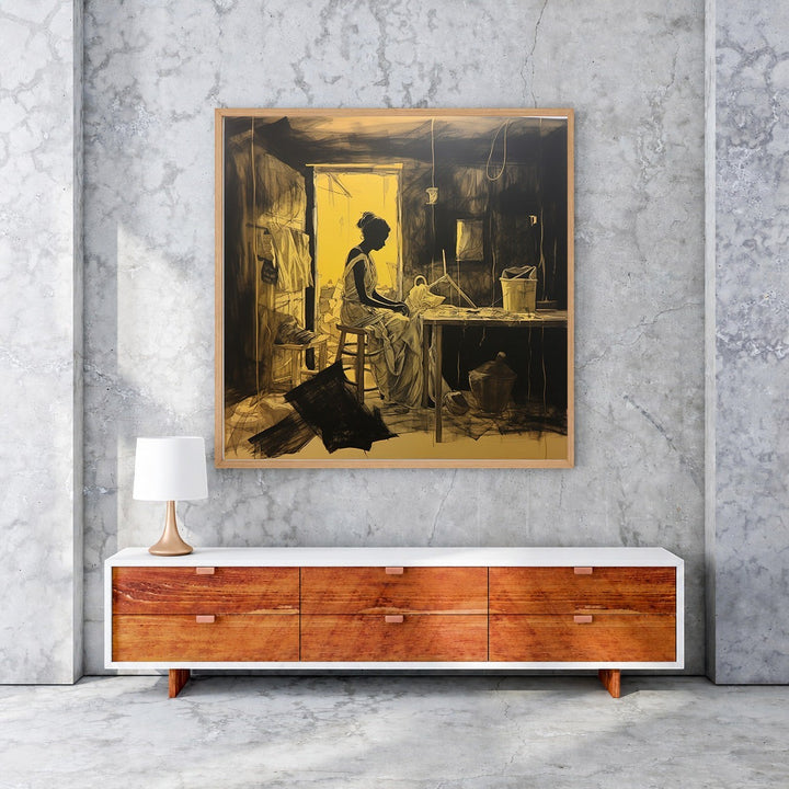 Wadi Home The Weaver's Solitude wall art, a framed painting in black and ochre depicting a woman weaving.