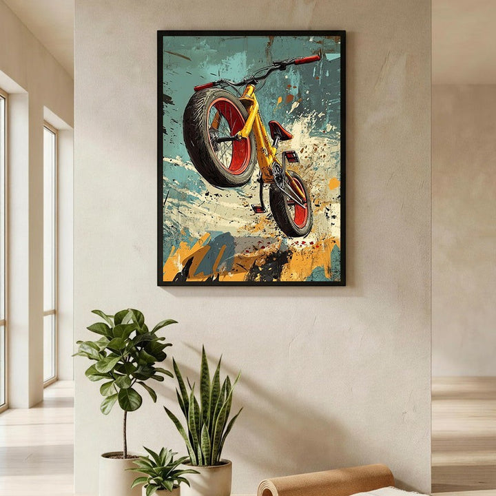 Wadi Home dynamic yellow bicycle art print with red accents, mid-air action, abstract energetic background.