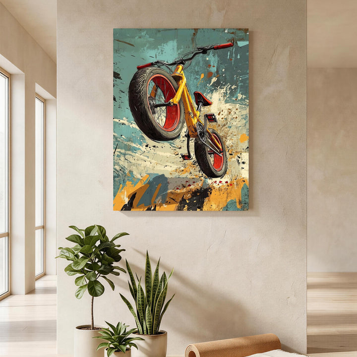 Wadi Home dynamic yellow bicycle art print with red accents, mid-air action against abstract background.