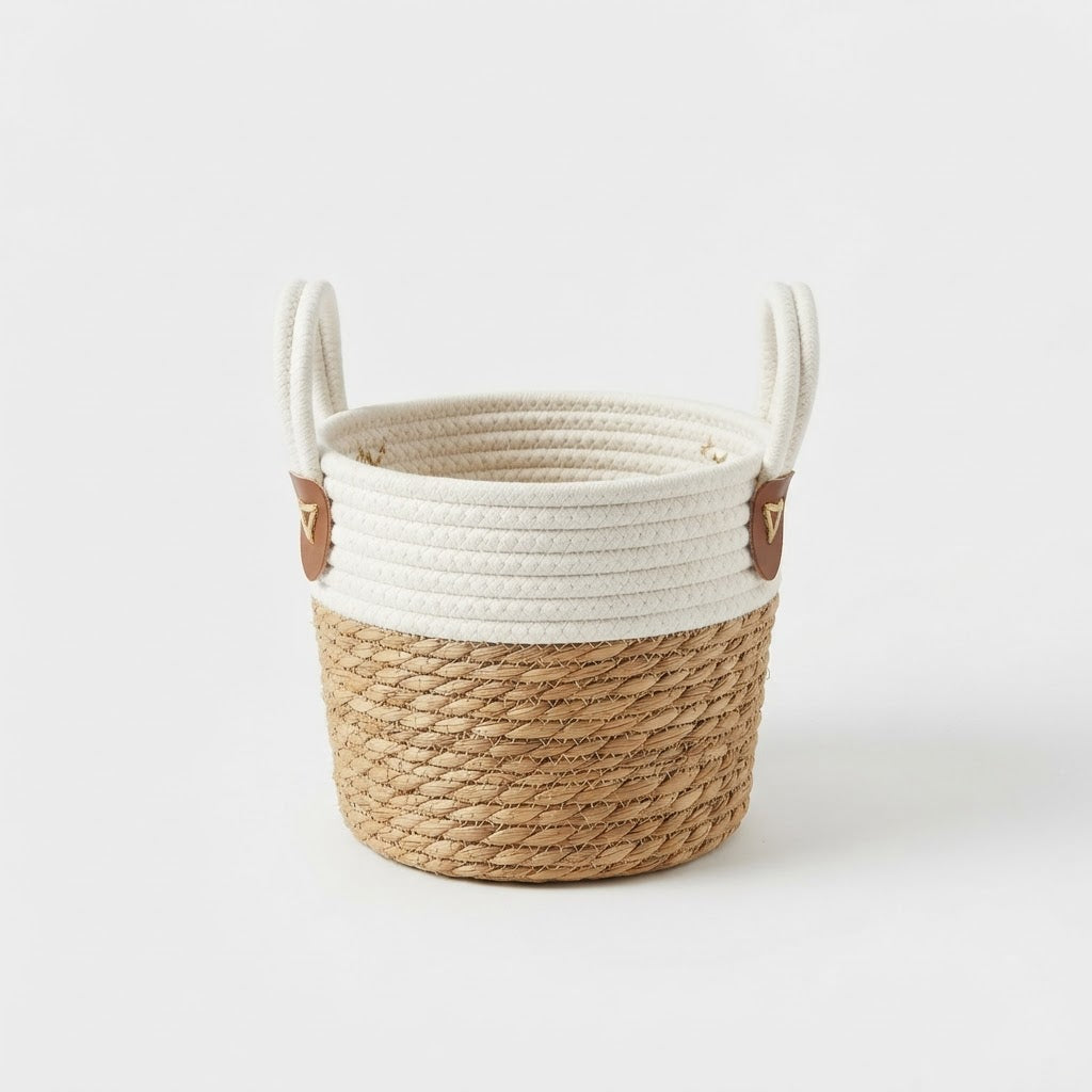 White and natural jute basket planter with loop handles and brown attachment tabs on a plain white studio background.