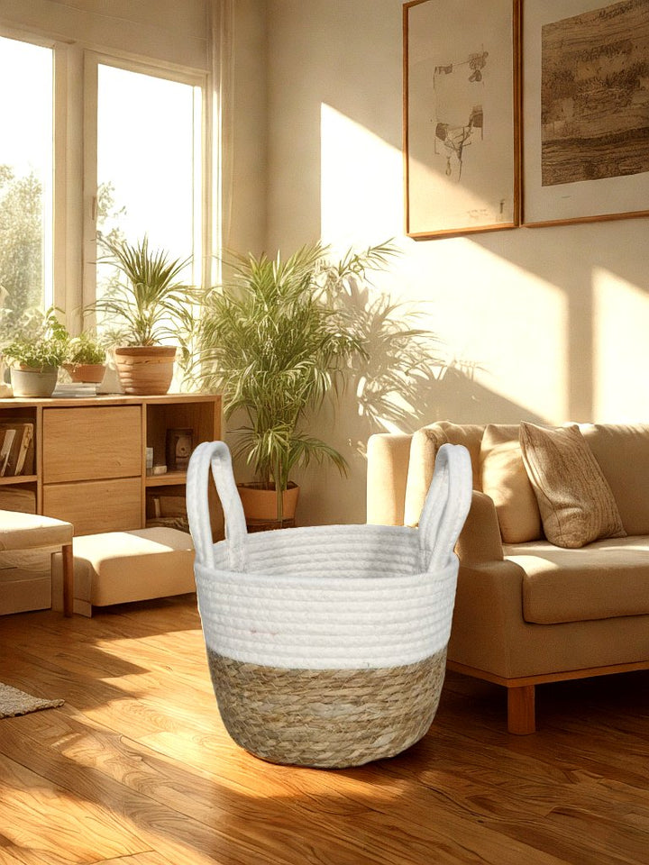 White and natural jute basket planter with white rope handles styled in a warm living room.