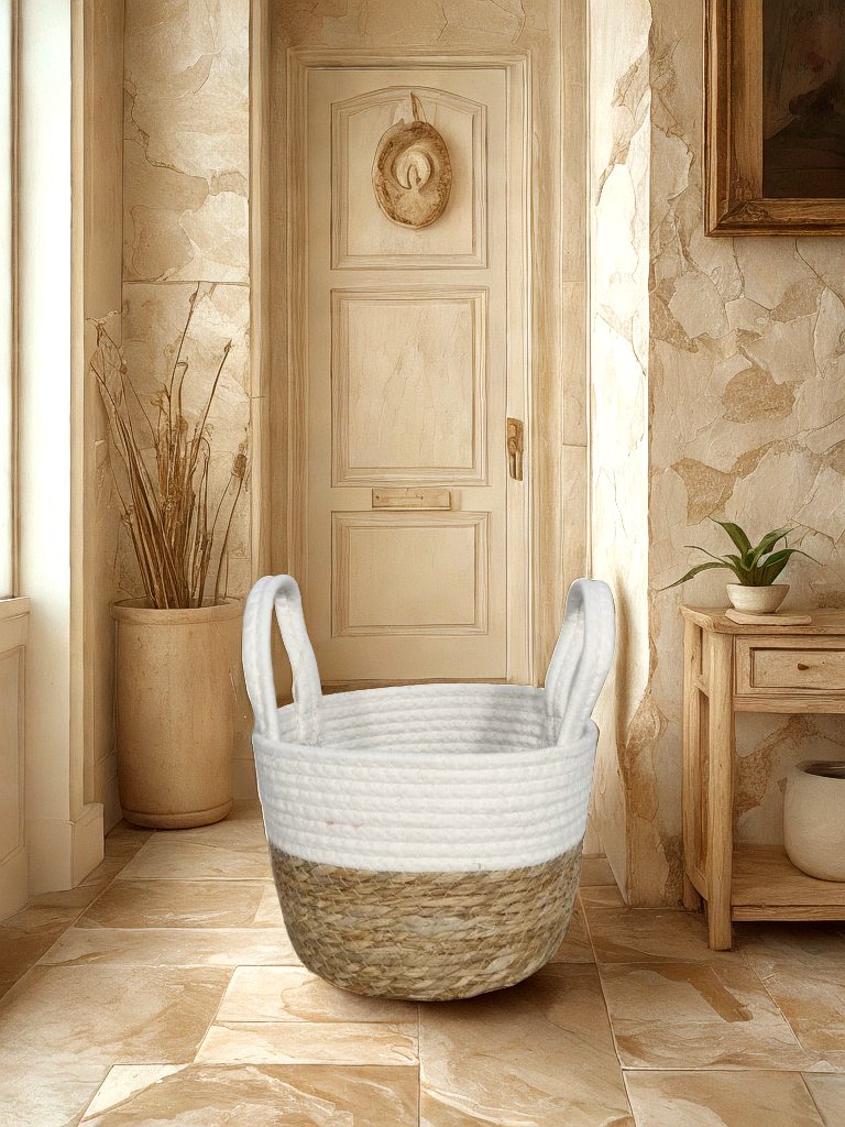 White and natural jute basket planter with white rope handles displayed in a neutral entryway.